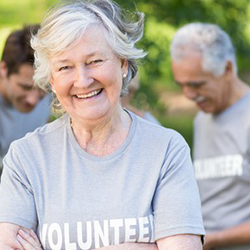 Happy volunteer grandmother smiling at camera