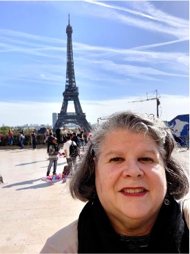 Barbar Paulson posing in front of Eiffel Tower