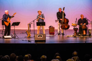 Musicians on stage at Oasis concert