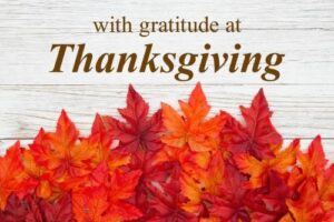 Orange fall leaves with the words, "With Gratitude at Thanksgiving"