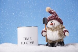 Snowman standing next to a cup that says "Time to Give"
