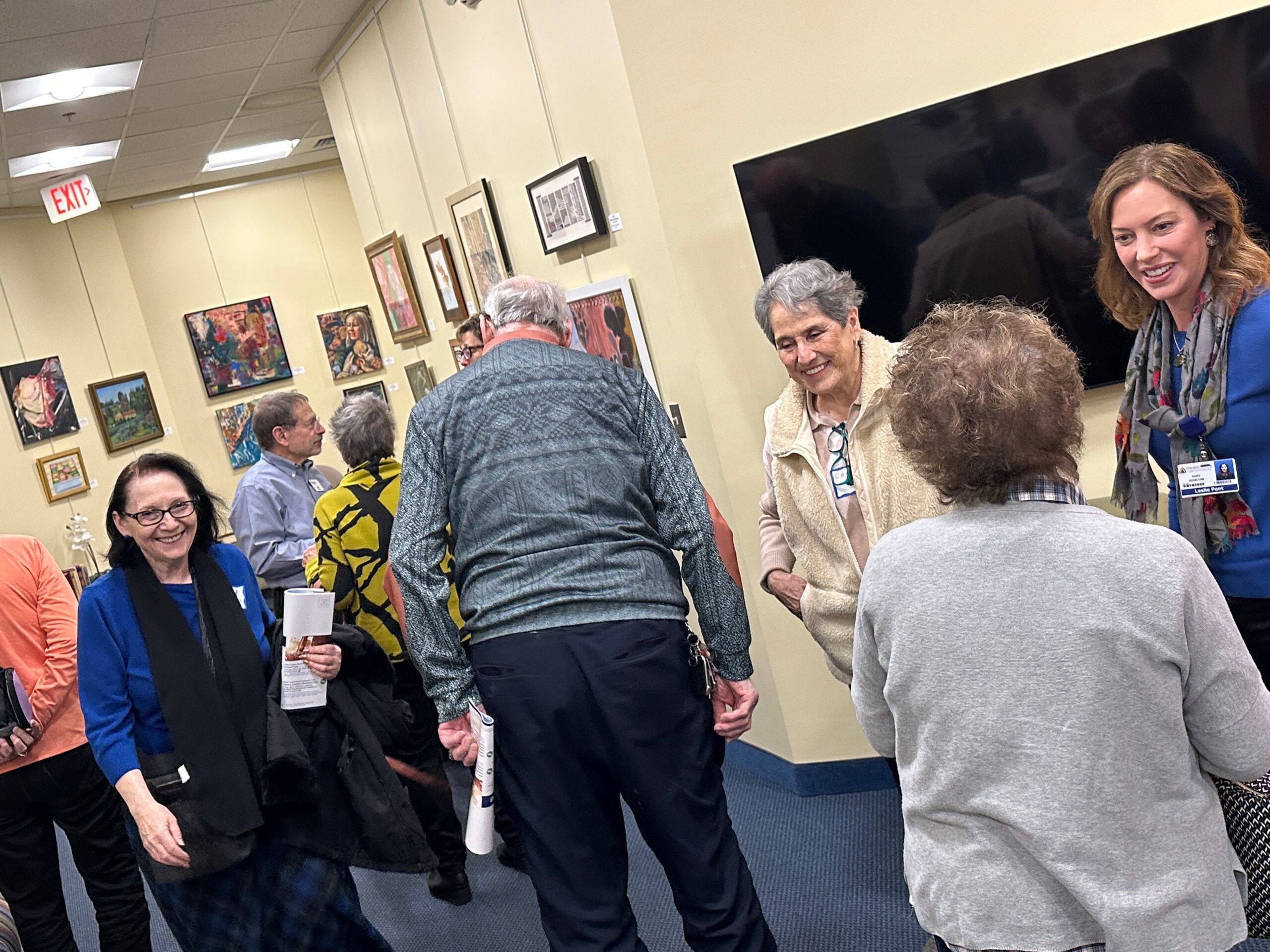 People gathering and talking in Oasis lobby