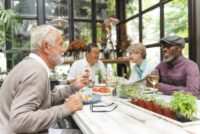 Older adults sitting around a table socializing